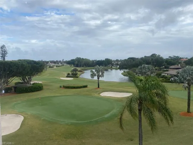 View of property's community featuring a water view, view of golf course, and a putting area