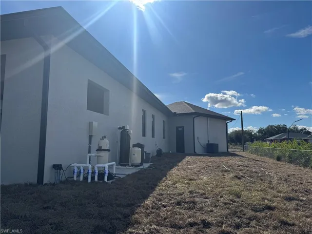 Back of house with stucco siding and a patio