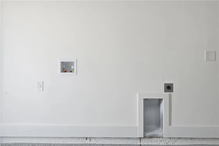 Washroom featuring hookup for an electric dryer and hookup for a washing machine