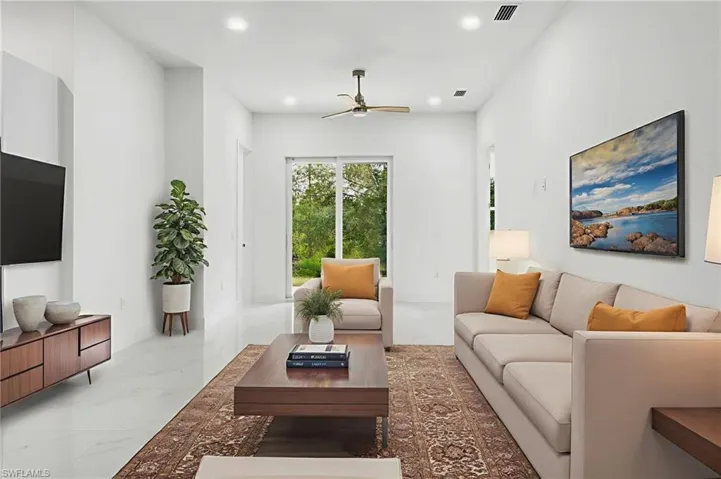 Living area with marble look tiles, recessed lighting, and ceiling fan