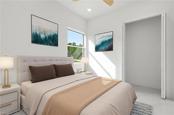 Bedroom featuring light marble finish floors, a ceiling fan, and recessed lighting