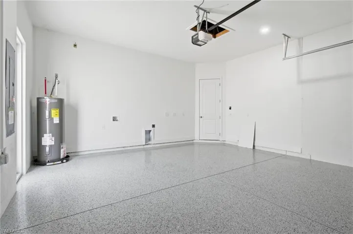 Garage with water heater and a garage door opener