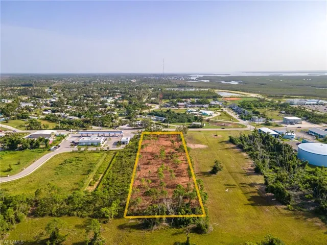 Overview of rural landscape with property parcel outlined and large plots for crops