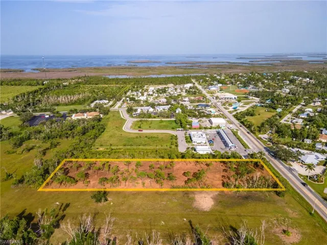 Aerial overview of property's location featuring property boundaries highlighted and a nearby body of water