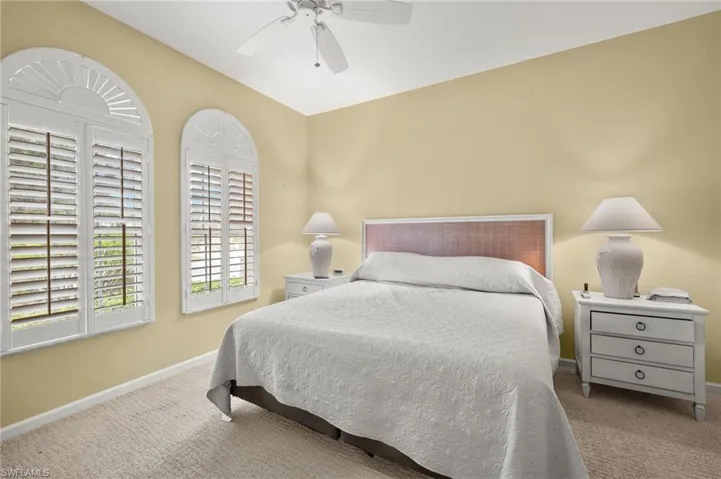 Bedroom featuring light colored carpet and ceiling fan
