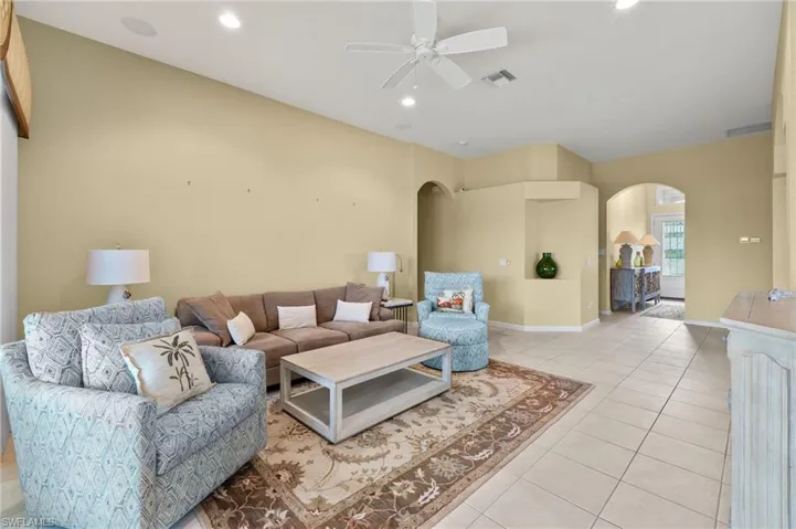 Tiled living room featuring ceiling fan