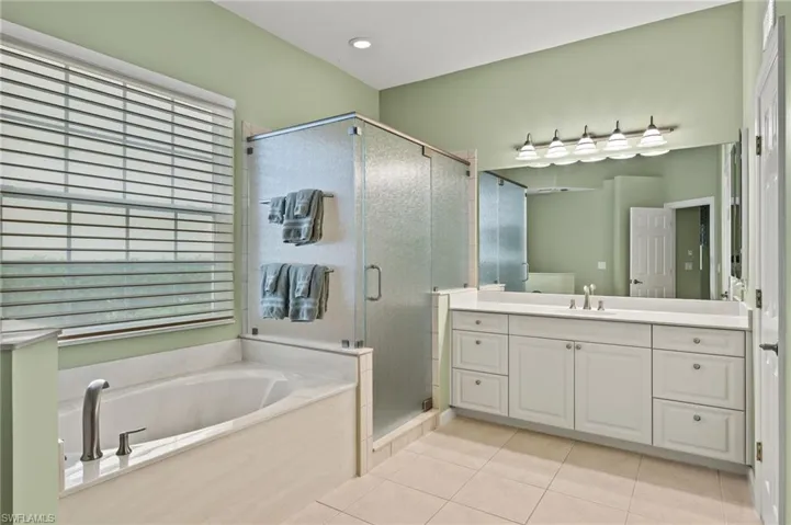Bathroom with vanity, independent shower and bath, and tile patterned floors
