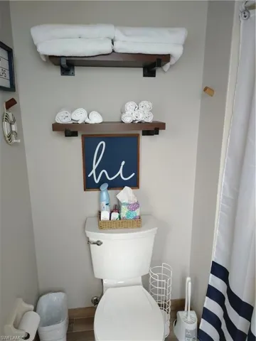 Bathroom featuring curtained shower and wood finished floors