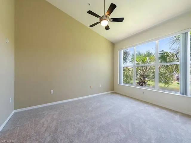 Spare room with carpet, lofted ceiling, and ceiling fan