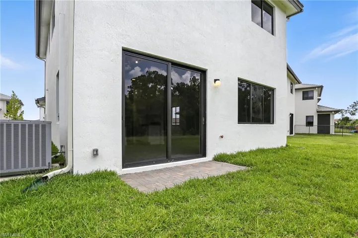 Back of house with a patio and stucco siding