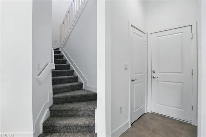 Staircase featuring tile patterned floors