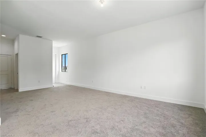Empty room featuring light carpet and recessed lighting