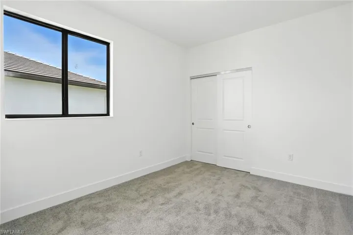 Unfurnished bedroom featuring carpet flooring and a closet