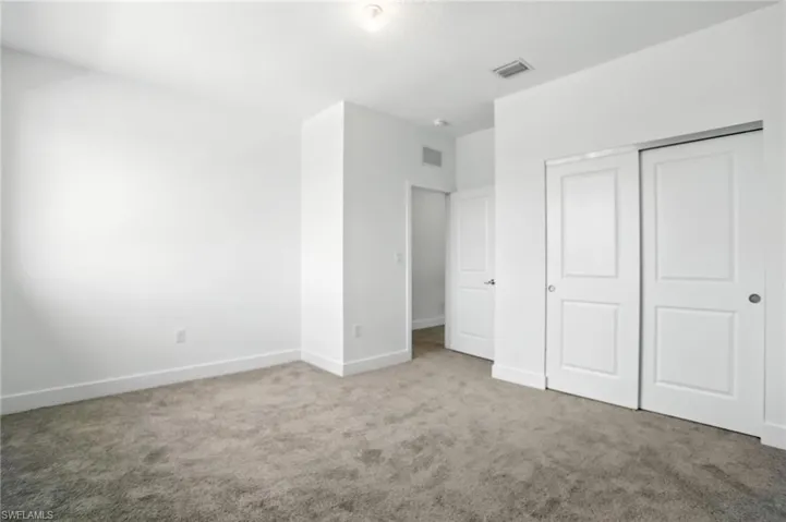 Unfurnished bedroom featuring carpet floors and a closet