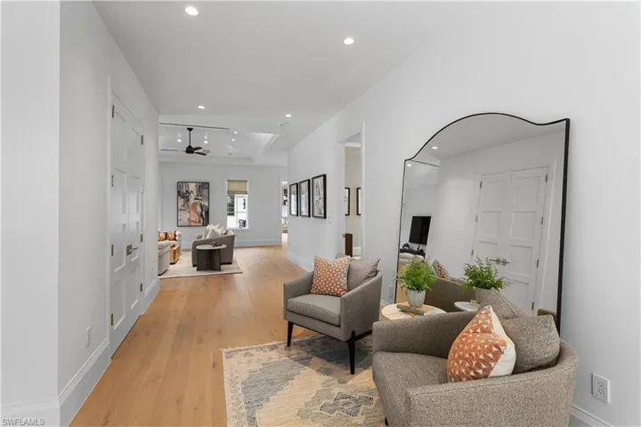 Living area featuring recessed lighting, light wood-type flooring, a ceiling fan, and baseboards