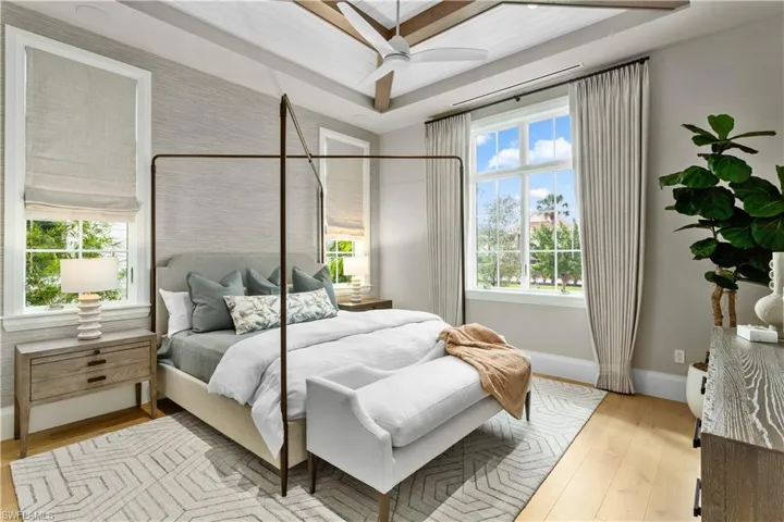 Bedroom with baseboards, hardwood / wood-style flooring, and a ceiling fan