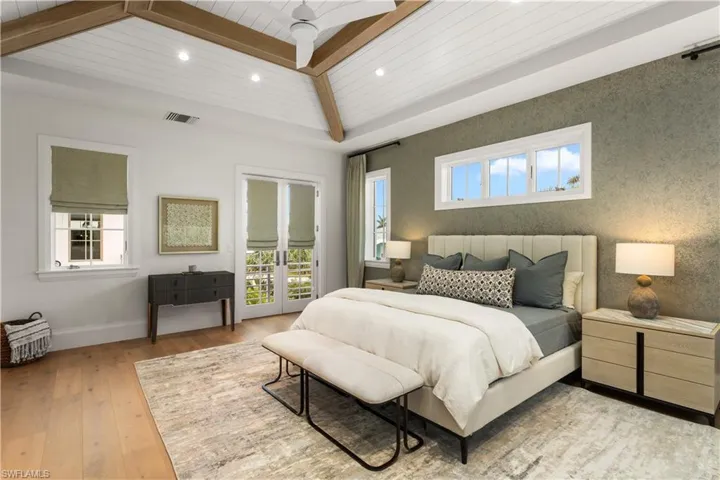 Bedroom with access to outside, light wood finished floors, recessed lighting, wood ceiling with exposed beams, and multiple windows