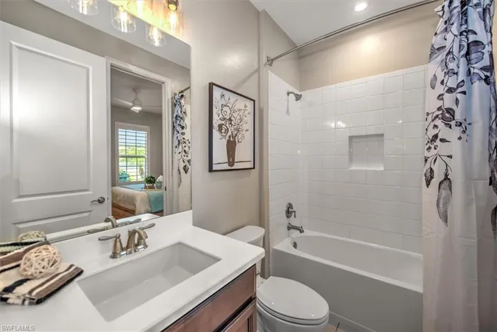 Bathroom with vanity, toilet, and shower / tub combo