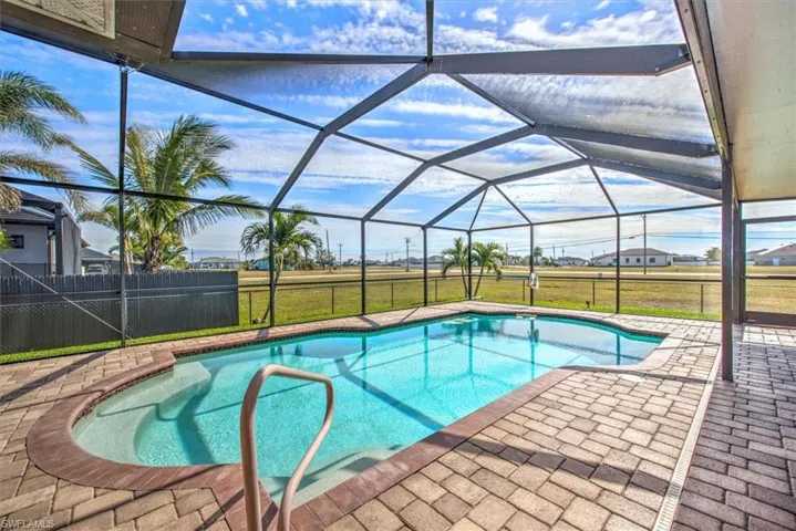 View of pool with a patio, a lanai, and a lawn
