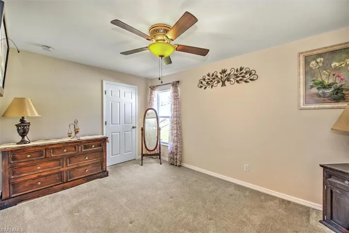 Carpeted bedroom with ceiling fan