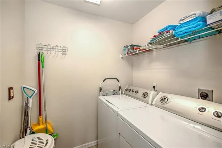 Washroom with washing machine and clothes dryer