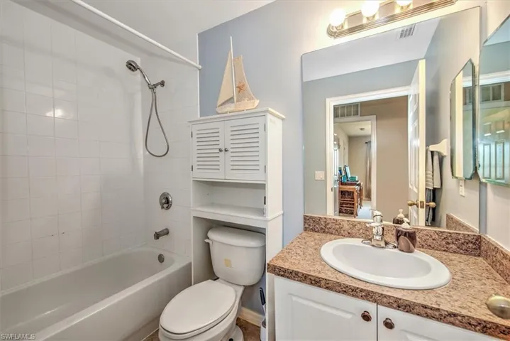 Full bathroom featuring vanity, toilet, and tiled shower / bath combo