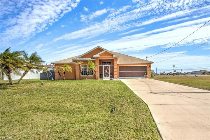 Ranch-style home with a garage and a front lawn