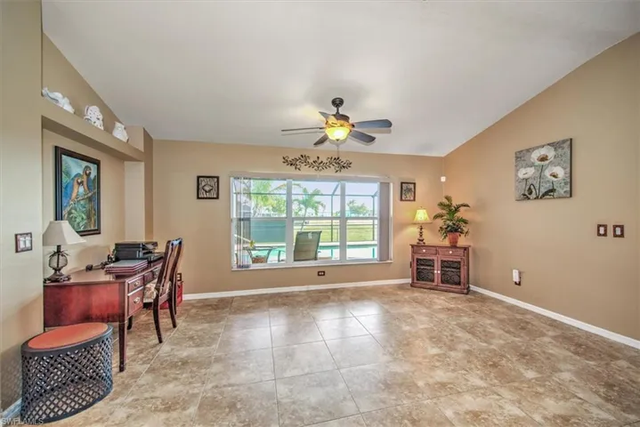 Home office with vaulted ceiling and ceiling fan