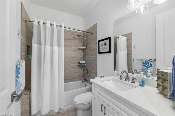 The guest bathroom with gorgeous counters & a tub/shower combo