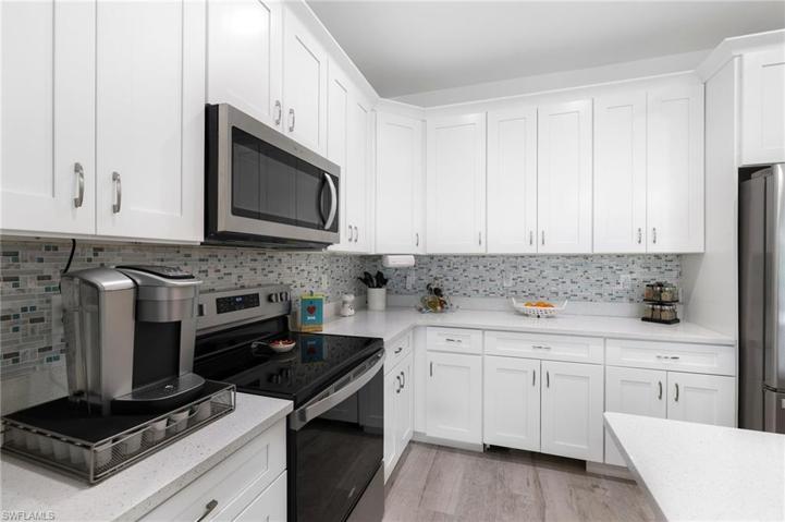 An impressive glass tile backsplash & lots of cabinets