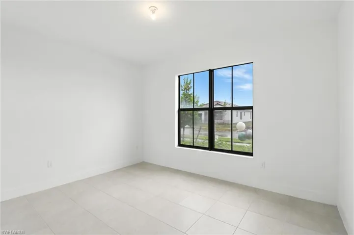 Spare room featuring light tile patterned flooring