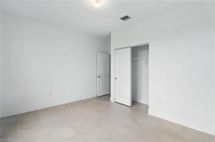 Unfurnished bedroom featuring baseboards and a closet
