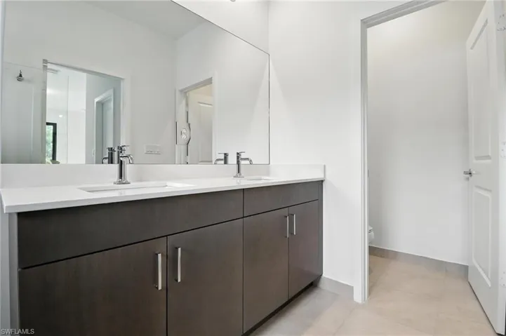Bathroom featuring double vanity and tile patterned floors