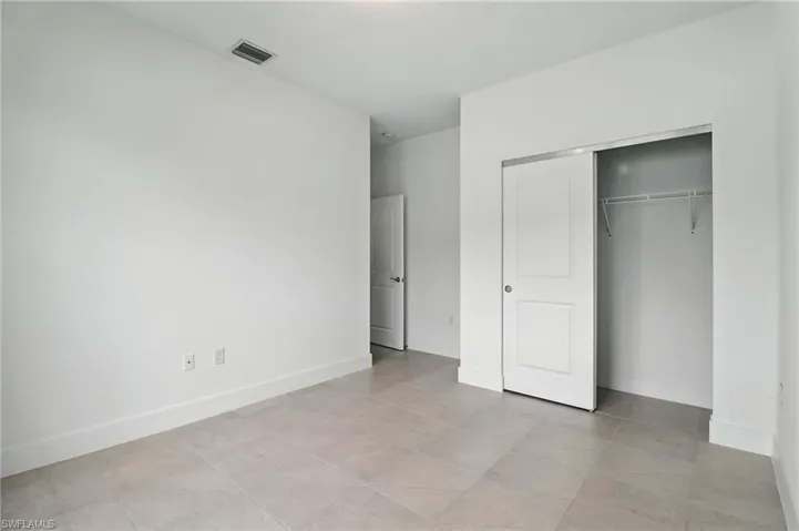 Unfurnished bedroom with a closet and baseboards
