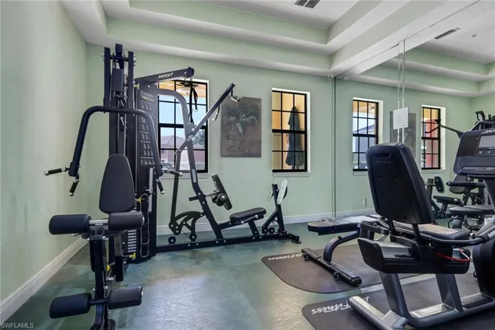 Workout area featuring a tray ceiling