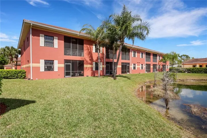 View of apartment building / complex featuring a water view