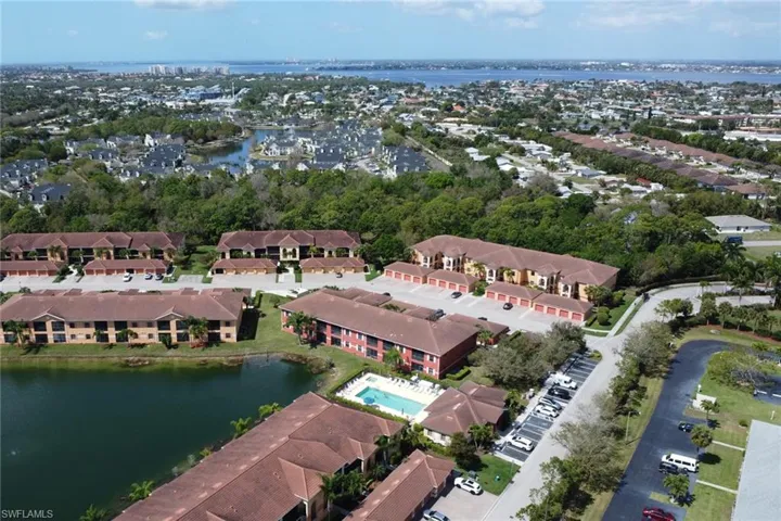 Aerial view of property and surrounding area with a nearby body of water