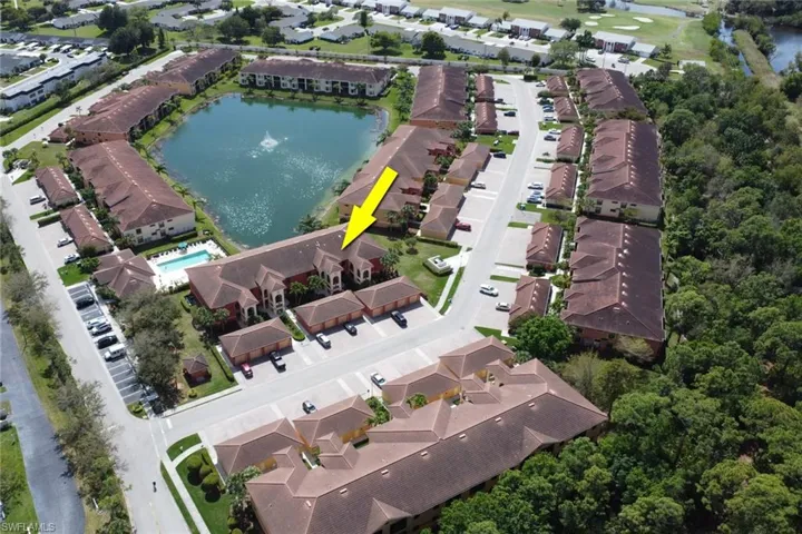 Aerial view of property and surrounding area with a nearby body of water and nearby suburban area
