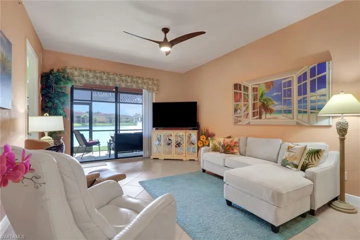 Living room featuring a ceiling fan and light tile patterned floors