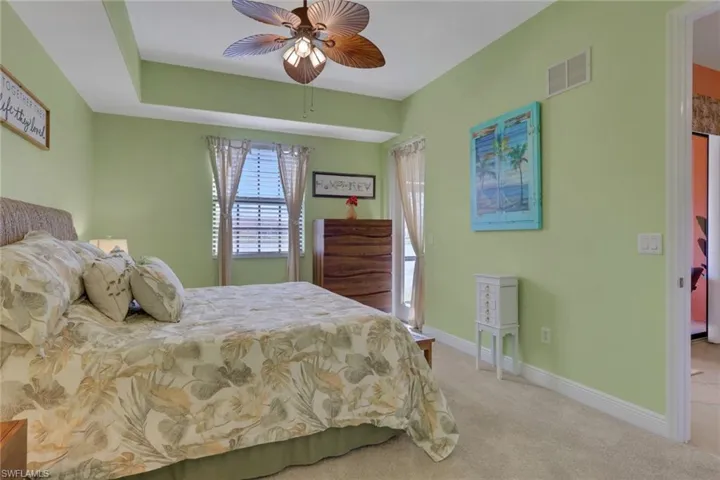 Bedroom featuring light carpet and a ceiling fan
