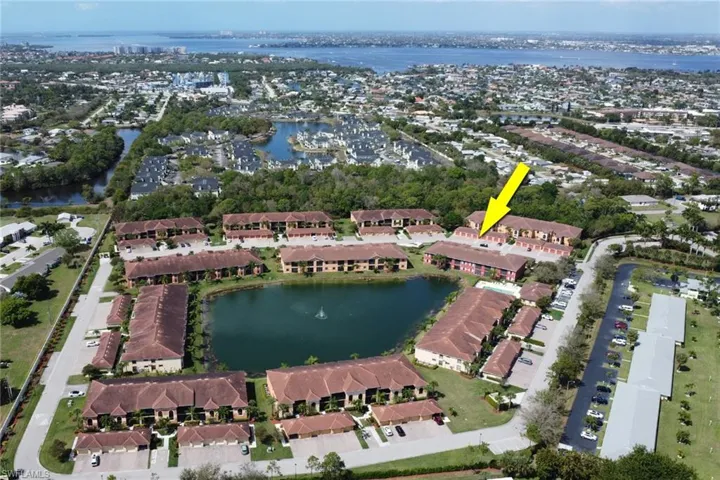 Aerial overview of property's location with a nearby body of water and nearby suburban area