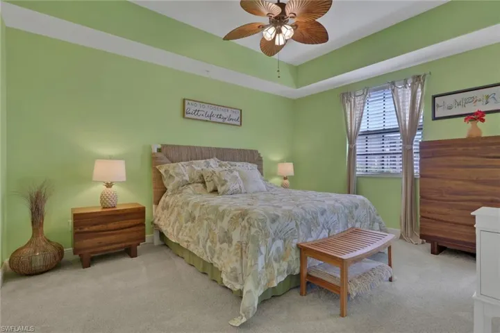 Carpeted bedroom featuring baseboards and a ceiling fan