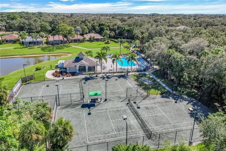 Aerial view of a pool area and a large body of water