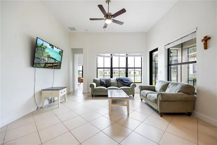 Living room featuring ceiling fan and light tile patterned floors