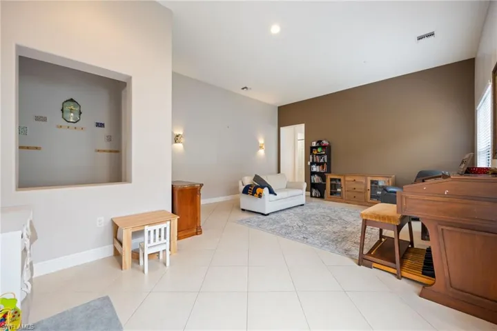 Living area with baseboards and light tile patterned flooring