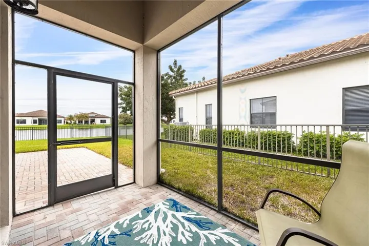 Sunroom featuring a water view and a residential view