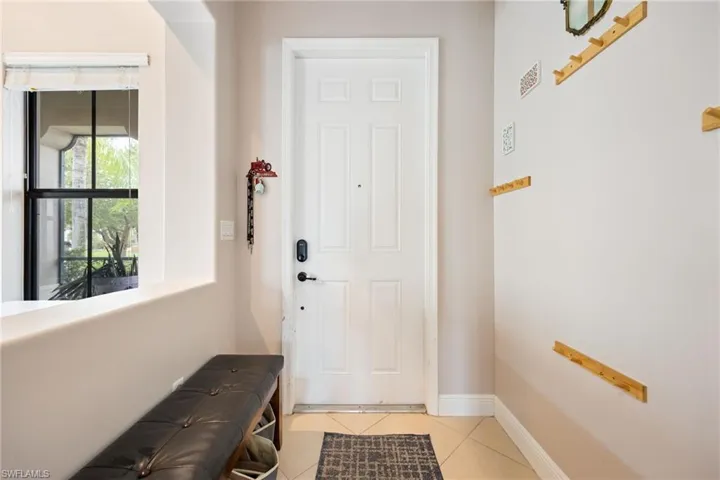 Doorway featuring tile patterned floors and baseboards