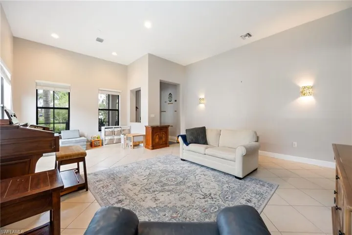 Living area featuring light tile patterned flooring and recessed lighting