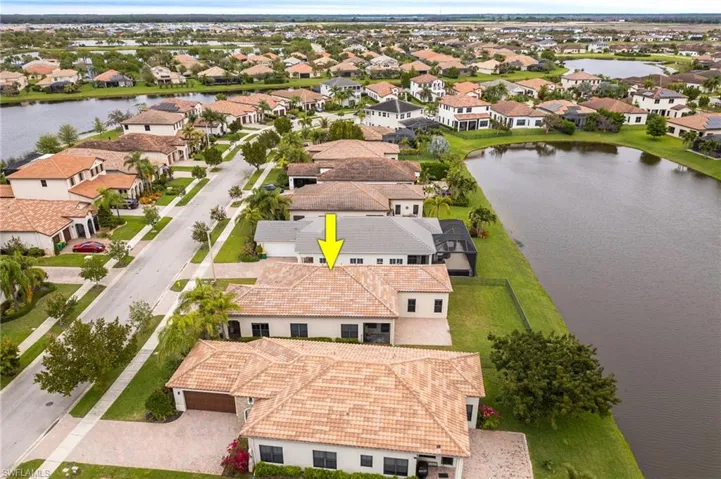 Aerial perspective of suburban area featuring a nearby body of water
