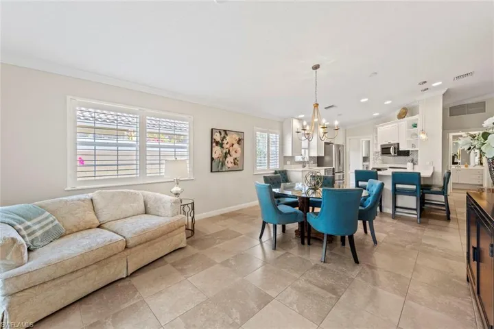 Dining area with recessed lighting, visible vents, ornamental molding, baseboards, and a notable chandelier